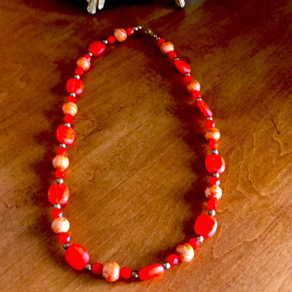 So unique! And orange!! Measures about 20 inches long super fun necklace to have